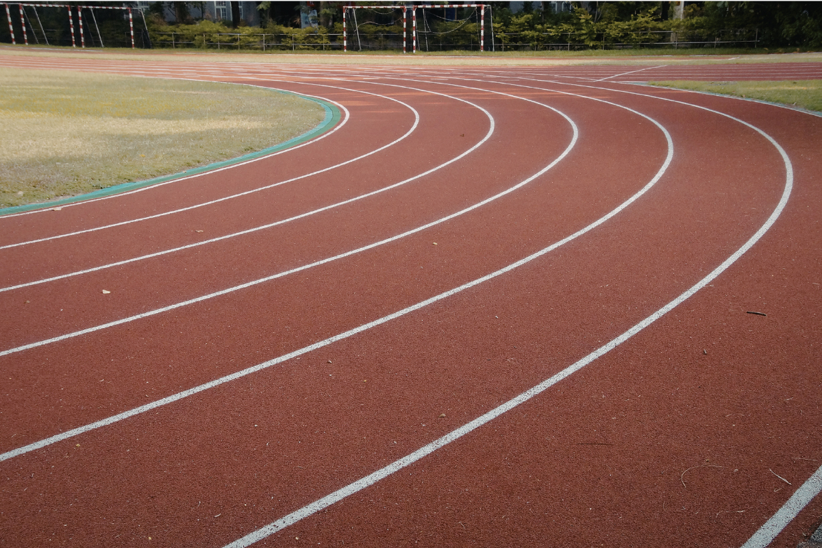 Person alternating between high-intensity sprinting and steady jogging on a track